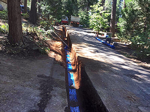 Road dug down and prepped for new waterline installation.